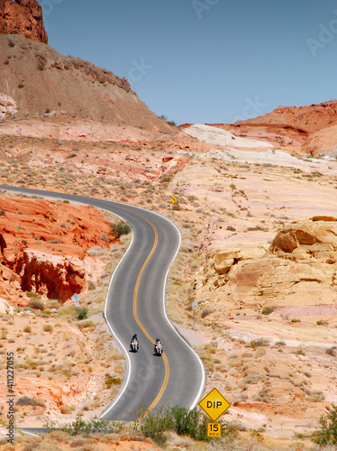 motorcycle riding in Valley of fire State Parkt on empty highway in scenic landscape