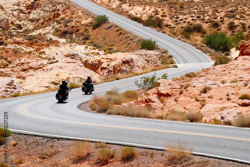 motorcycle riding in Valley of fire State Parkt on empty highway in scenic landscape