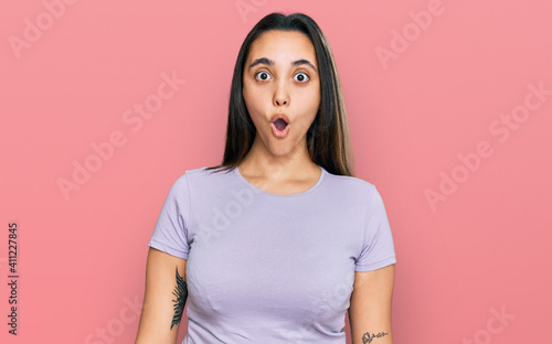 Young hispanic woman wearing casual clothes scared and amazed with open mouth for surprise, disbelief face