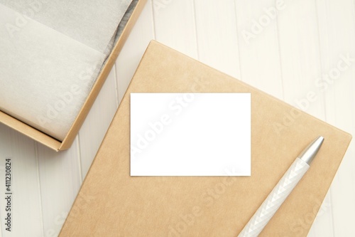 Small thank you card mockup on gift box, empty horizontal business card.