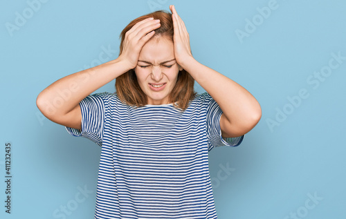 Young caucasian woman wearing casual clothes suffering from headache desperate and stressed because pain and migraine. hands on head.