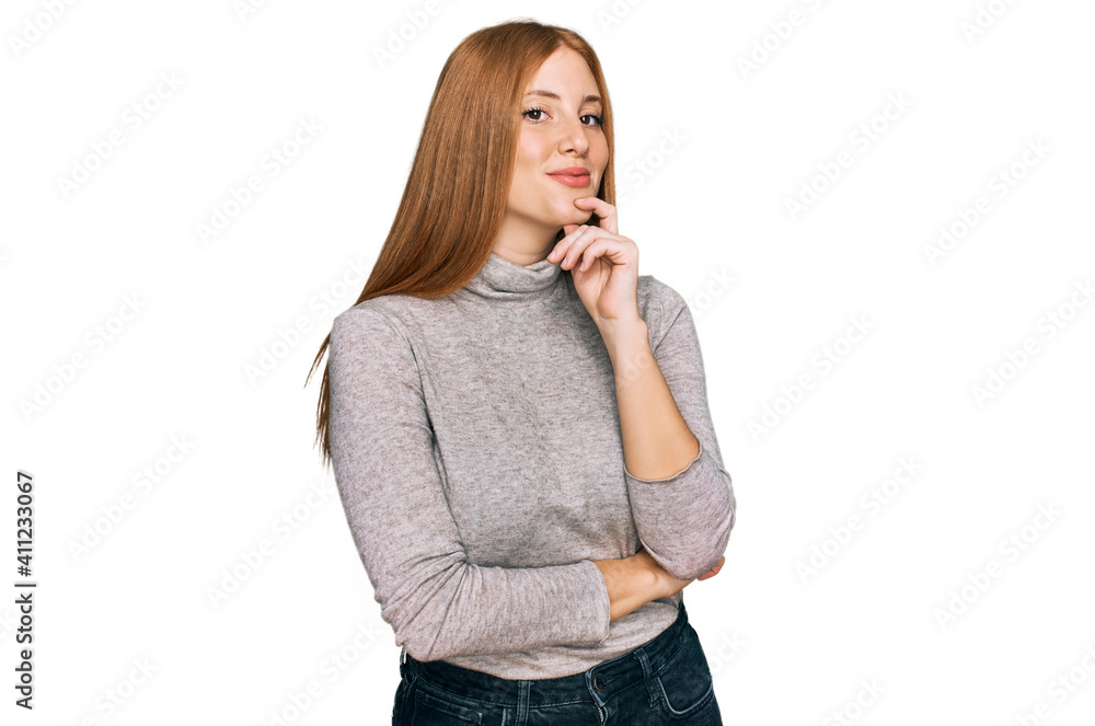 Young irish woman wearing casual clothes looking confident at the camera with smile with crossed arms and hand raised on chin. thinking positive.