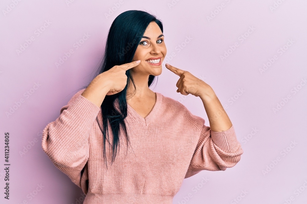 Young caucasian woman wearing casual clothes smiling cheerful showing and pointing with fingers teeth and mouth. dental health concept. Young caucasian woman wearing casual clothes smiling cheerful showing and pointing with fingers teeth and mouth. dental health concept.