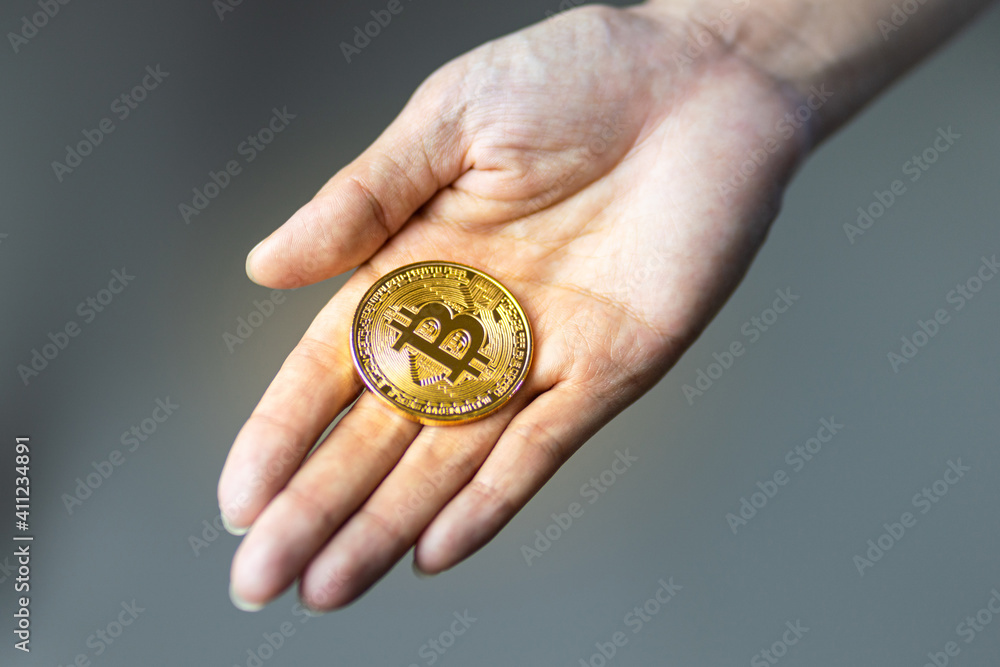 Bitcoin (BTC) coin top most value cryptocurrency in people hand. Money business and finacial investment concept photo. Bitcoin (BTC) coin top most value cryptocurrency in people hand. Money business and finacial investment concept photo.