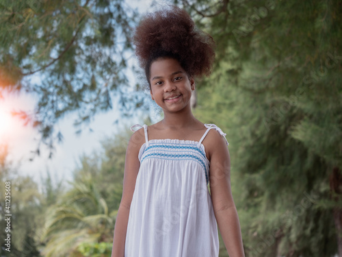 Outdoor portrait of a smiling young beautiful African American girl looking at the camera..