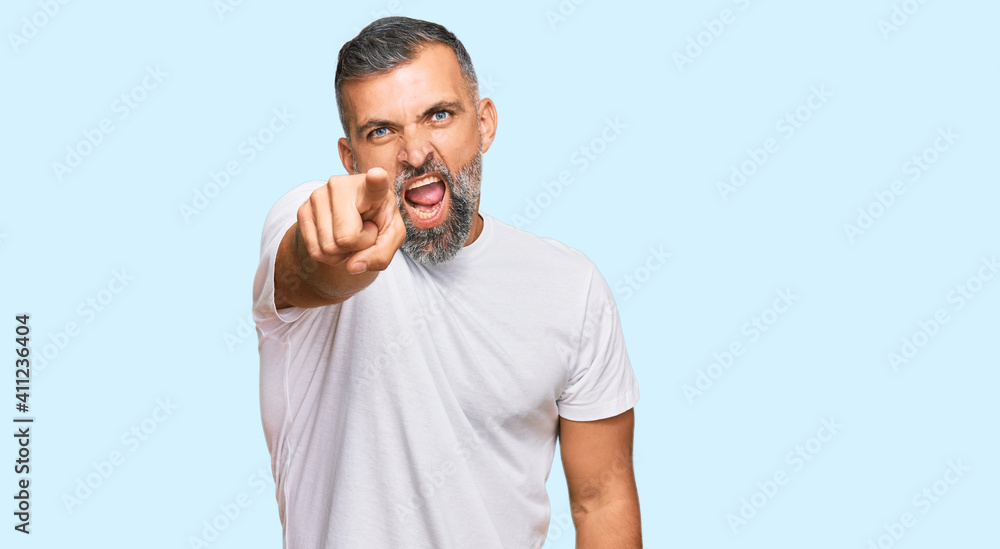 Middle age handsome man wearing casual white tshirt pointing displeased and frustrated to the camera, angry and furious with you Middle age handsome man wearing casual white tshirt pointing displeased and frustrated to the camera, angry and furious with you