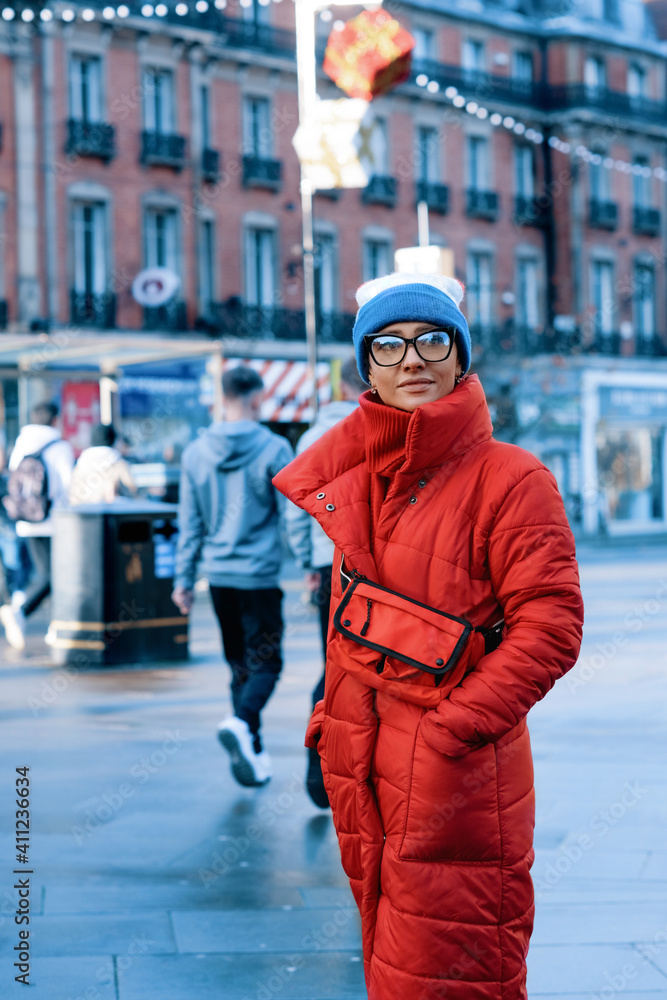 happy woman in red coat, hat walking around city in cold weather happy woman in red coat, hat walking around city in cold weather