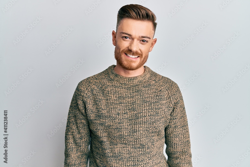 Young redhead man wearing casual winter sweater with a happy and cool smile on face. lucky person. Young redhead man wearing casual winter sweater with a happy and cool smile on face. lucky person.