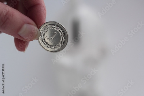 Hand holding a Polish zloty coin. photo