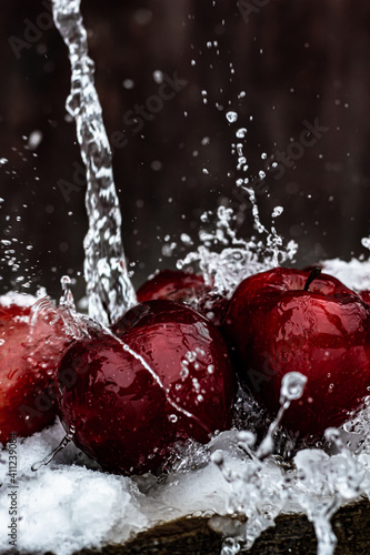 Water splashes on red apples.