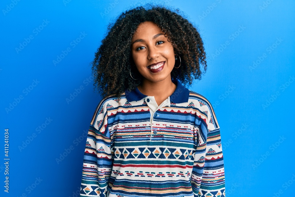Beautiful african american woman with afro hair wearing casual clothes with a happy and cool smile on face. lucky person. Beautiful african american woman with afro hair wearing casual clothes with a happy and cool smile on face. lucky person.
