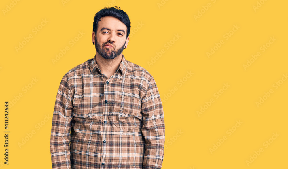 Young hispanic man wearing casual clothes looking sleepy and tired, exhausted for fatigue and hangover, lazy eyes in the morning. Young hispanic man wearing casual clothes looking sleepy and tired, exhausted for fatigue and hangover, lazy eyes in the morning.