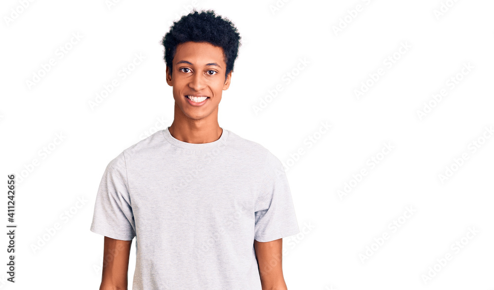 Young african american man wearing casual clothes with a happy and cool smile on face. lucky person. Young african american man wearing casual clothes with a happy and cool smile on face. lucky person.