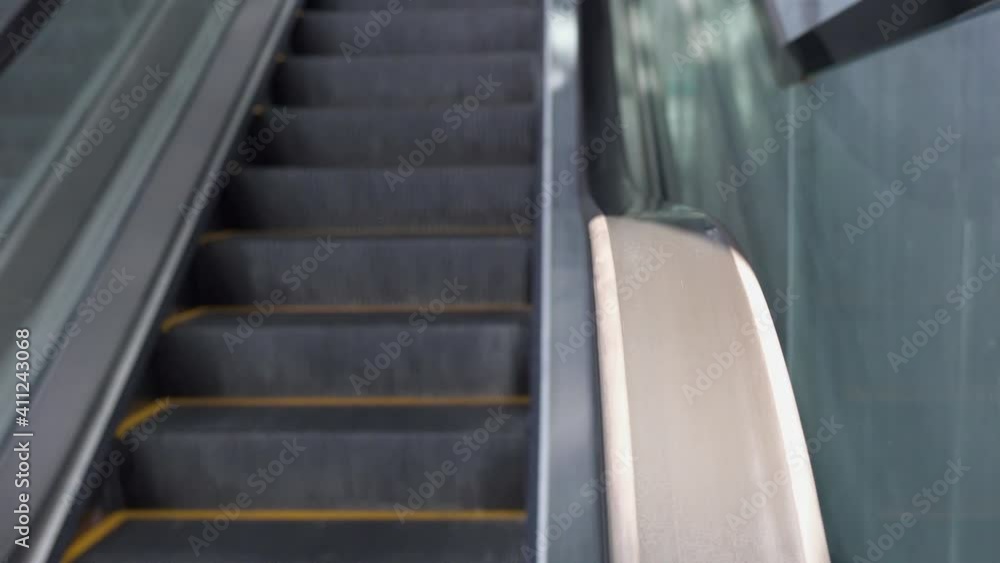 Escalator in a modern building. The escalator goes up. Escalator in a modern building. The escalator goes up.