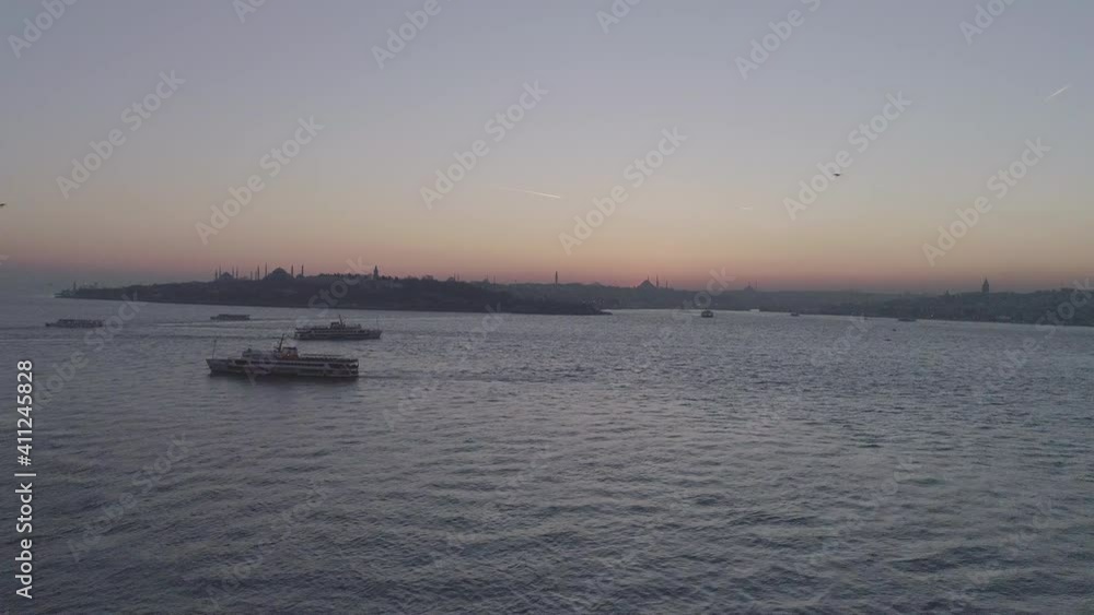 Cityscape of Istanbul with silhouettes of ancient mosques and minarets at sunset. Panoramic view, The Maiden's Tower, Galata Tower, Hagia Sophia, The Blue Mosque and Topkapı Palace in Istanbul. Cityscape of Istanbul with silhouettes of ancient mosques and minarets at sunset. Panoramic view, The Maiden's Tower, Galata Tower, Hagia Sophia, The Blue Mosque and Topkapı Palace in Istanbul.