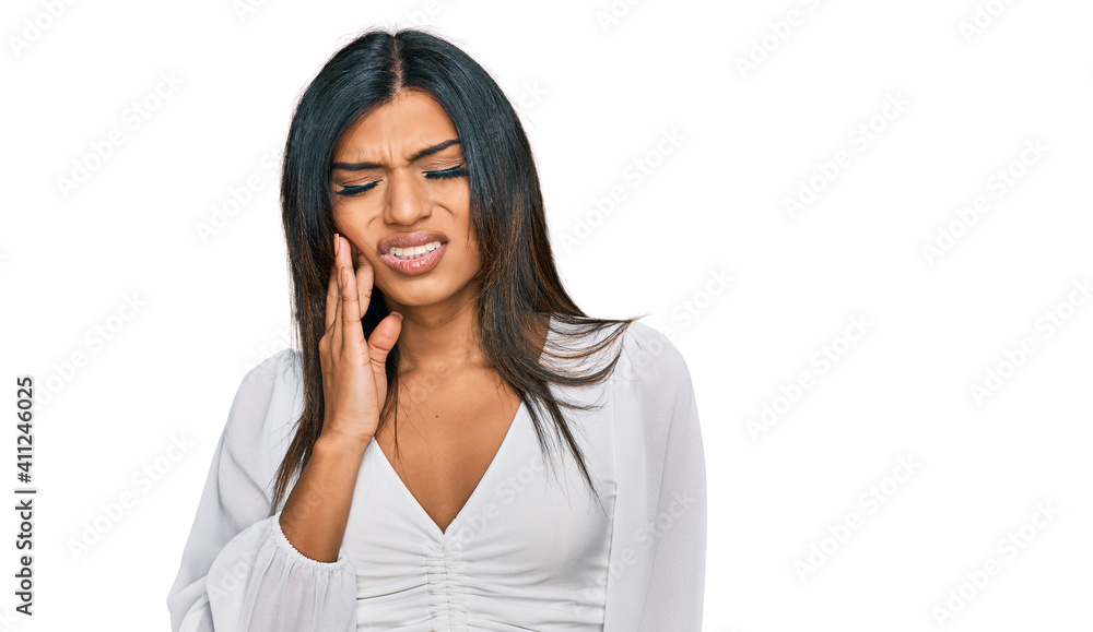 Young latin transsexual transgender woman wearing casual clothes touching mouth with hand with painful expression because of toothache or dental illness on teeth. dentist Young latin transsexual transgender woman wearing casual clothes touching mouth with hand with painful expression because of toothache or dental illness on teeth. dentist