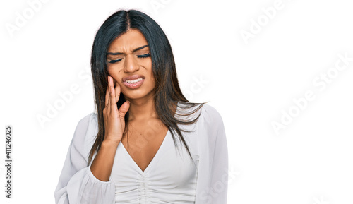 Young latin transsexual transgender woman wearing casual clothes touching mouth with hand with painful expression because of toothache or dental illness on teeth. dentist