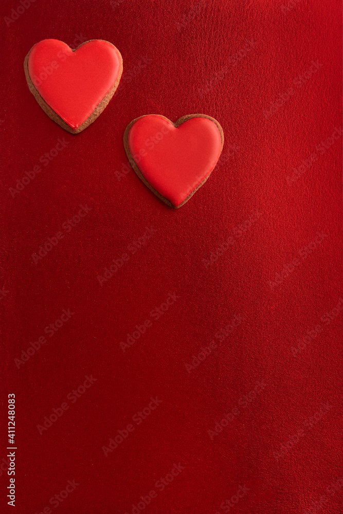 Two red hearts on red background Vertical frame. Copy space.