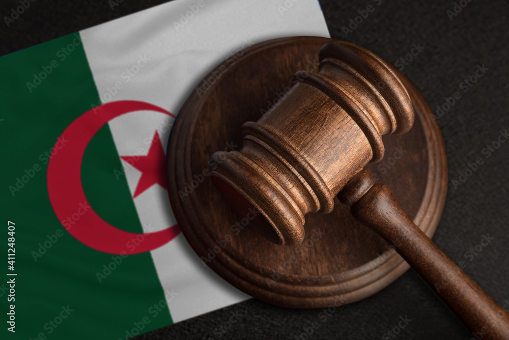 Judge gavel and flag of Algeria. Law and justice in Algeria. Violation of rights and freedoms