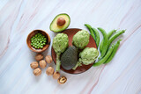 Artichoke, avocado, walnuts and green beans on marble background, Healthy and healthy life concept