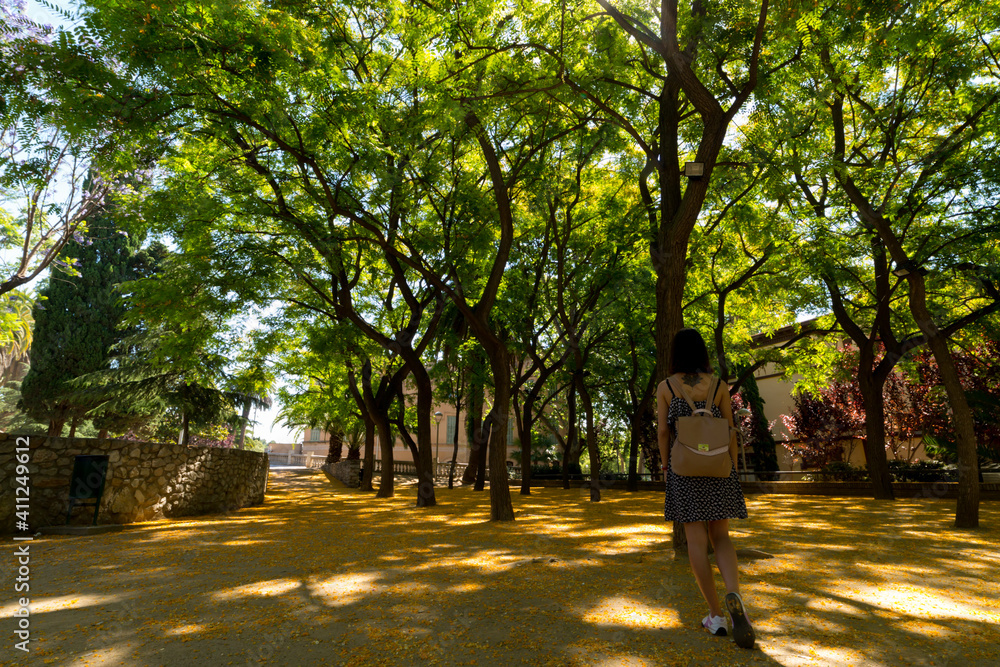 white Spanish woman walking in the park white Spanish woman walking in the park