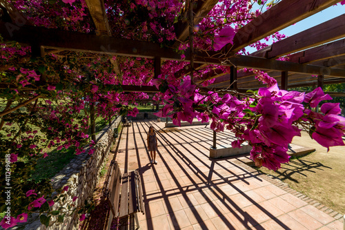 white woman with flowers in a garden
