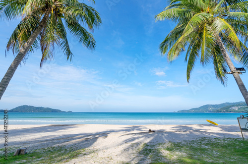 Fototapeta Naklejka Na Ścianę i Meble -  Coconut palm trees and turquoise sea in phuket patong beach. Summer nature vacation and tropical beach background concept