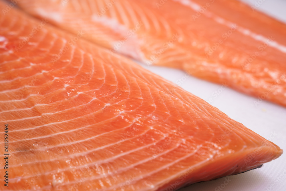 fresh salmon, salmon fillet, sliced appetizing salmon lying on the table in the kitchen