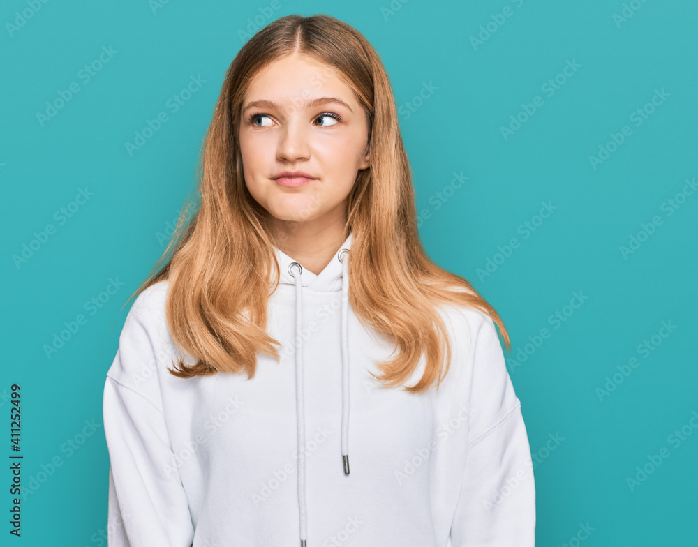 Beautiful young caucasian girl wearing casual sweatshirt smiling looking to the side and staring away thinking. Beautiful young caucasian girl wearing casual sweatshirt smiling looking to the side and staring away thinking.