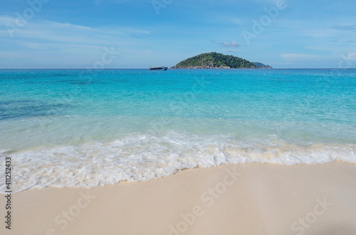 Beautiful beach and tropical sea with wave crashing on sandy shore Small island archipelago at Similan national park Thailand travel and tour concept