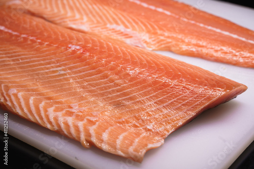 fresh salmon, salmon fillet, sliced appetizing salmon lying on the table in the kitchen