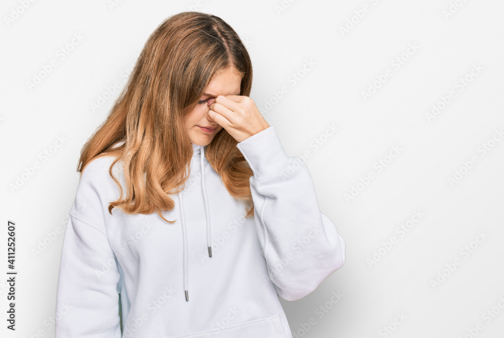 Beautiful young caucasian girl wearing casual sweatshirt tired rubbing nose and eyes feeling fatigue and headache. stress and frustration concept. Beautiful young caucasian girl wearing casual sweatshirt tired rubbing nose and eyes feeling fatigue and headache. stress and frustration concept.