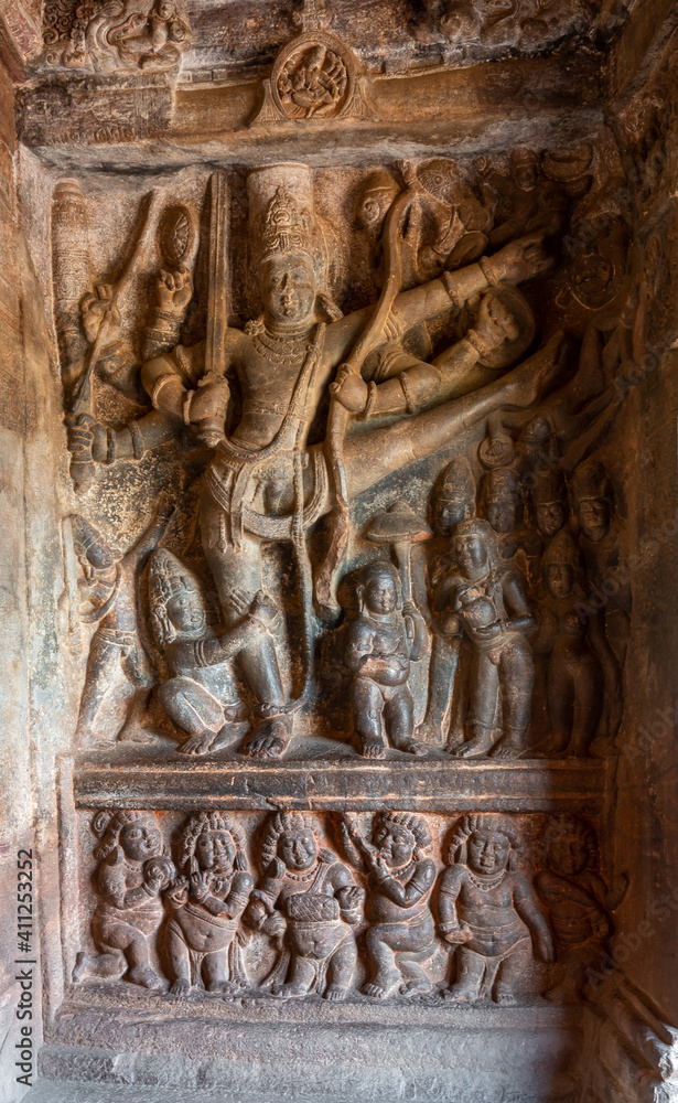 Badami, Karnataka, India - November 7, 2013: 2nd Cave temple above Agasthya Lake. Sculpture of Vishnu as Trivikrama taking first step. Legend of Vamana dwarf under leg,