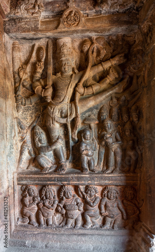 Badami, Karnataka, India - November 7, 2013: 2nd Cave temple above Agasthya Lake. Sculpture of Vishnu as Trivikrama taking first step. Legend of Vamana dwarf under leg, photo