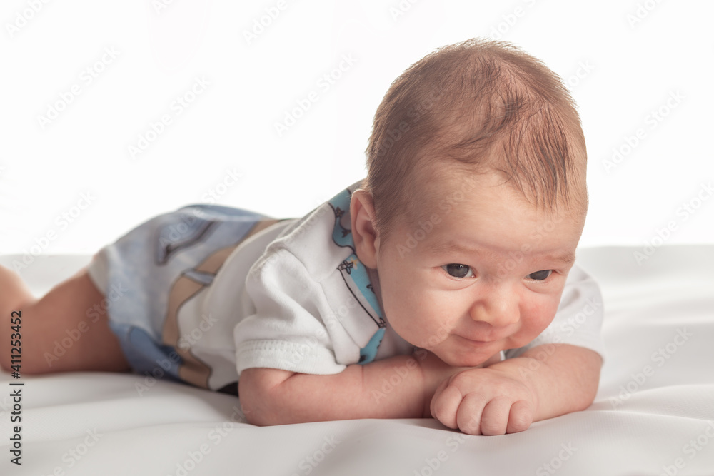 Smiling caucasian 1 month old child posing on the white isolated background. Smiling caucasian 1 month old child posing on the white isolated background.