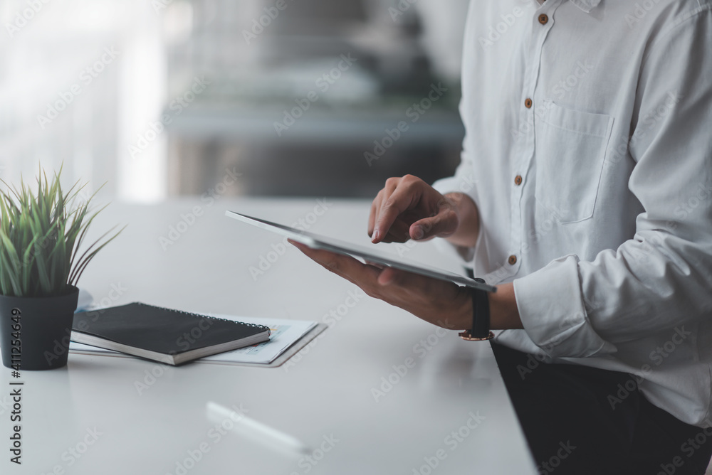Young man working with a tablet in a modern office. Young man working with a tablet in a modern office.