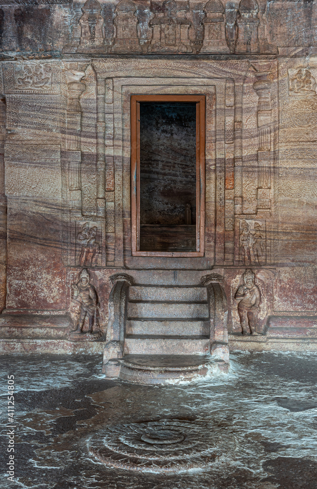 Badami, Karnataka, India - November 7, 2013: Cave temples above Agasthya Lake. Closeup of circular floor sculpture in front of sanctum in cave 3. Badami, Karnataka, India - November 7, 2013: Cave temples above Agasthya Lake. Closeup of circular floor sculpture in front of sanctum in cave 3.