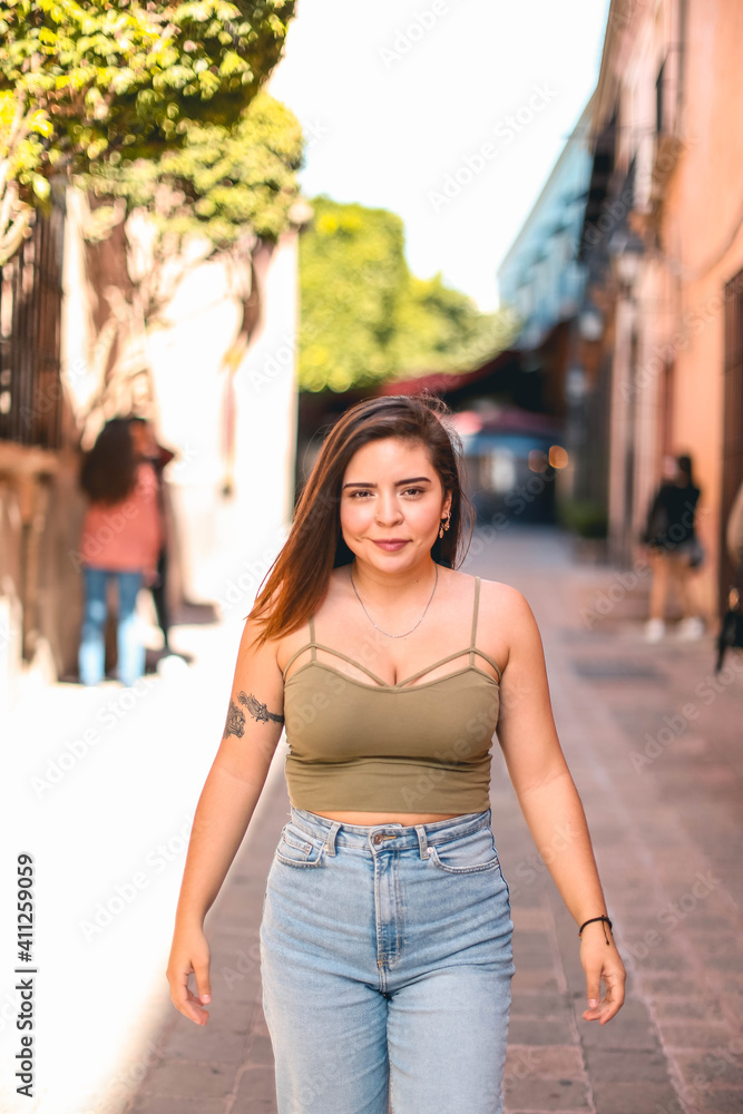 Portrait of young woman with nice hair in the city, mexico, fake henna tattoo in her arm