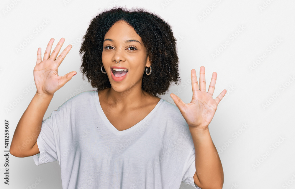 Young african american girl wearing casual clothes showing and pointing up with fingers number ten while smiling confident and happy. Young african american girl wearing casual clothes showing and pointing up with fingers number ten while smiling confident and happy.