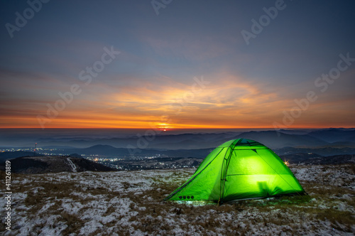 Tent on the background of the sunrise in winter in the mountains © onyx124