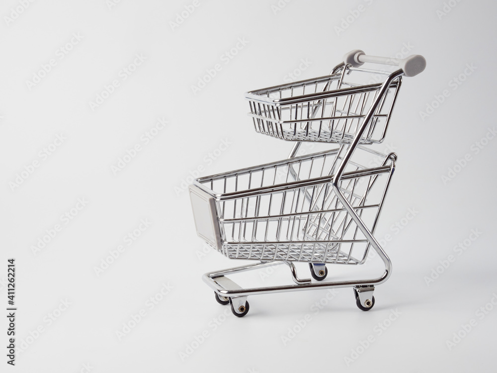 An empty grocery cart from a supermarket. There is a shortage of products in the store due to the coronavirus epidemic. Quarantine and isolation of the population in cities of many countries. An empty grocery cart from a supermarket. There is a shortage of products in the store due to the coronavirus epidemic. Quarantine and isolation of the population in cities of many countries.