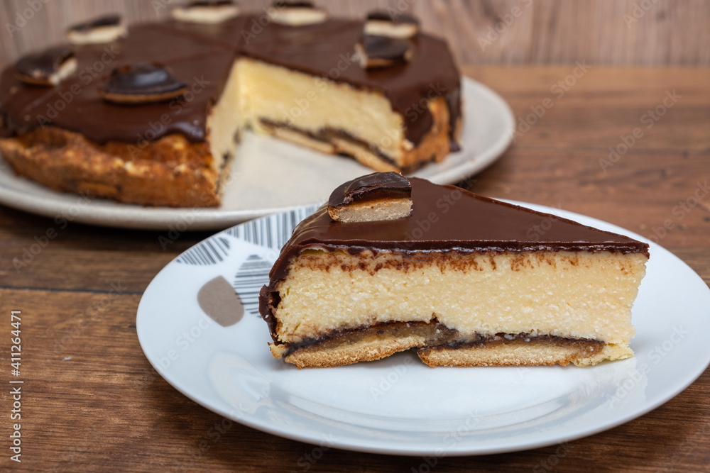 Cake with Chocolate Glaze and orange biscuit on wooden background