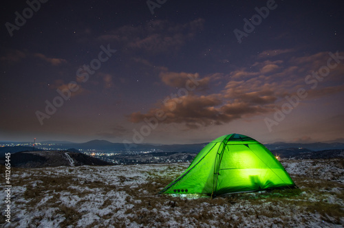 Tent on the background of a winter sunset in the mountains