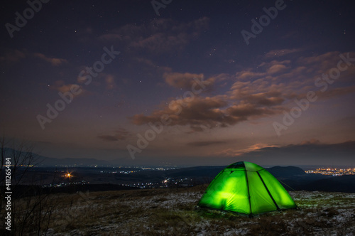Tent on the background of a winter sunset in the mountains © onyx124
