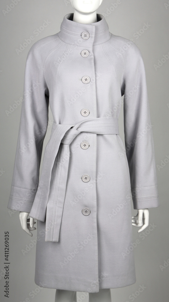 Gray coat on mannequin against gray background Gray coat on mannequin against gray background