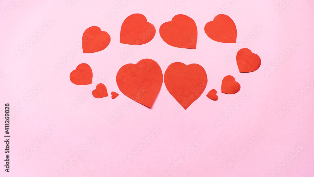 Red hearts on light pink background. Greeting card.