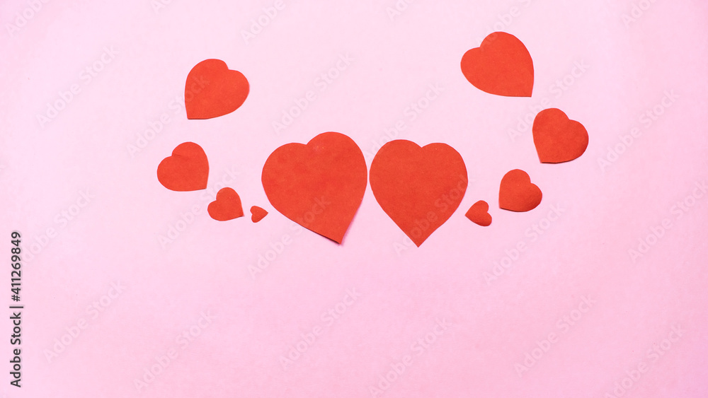 Red hearts on light pink background. Greeting card.