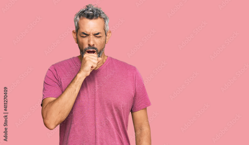Middle age grey-haired man wearing casual clothes feeling unwell and coughing as symptom for cold or bronchitis. health care concept. Middle age grey-haired man wearing casual clothes feeling unwell and coughing as symptom for cold or bronchitis. health care concept.