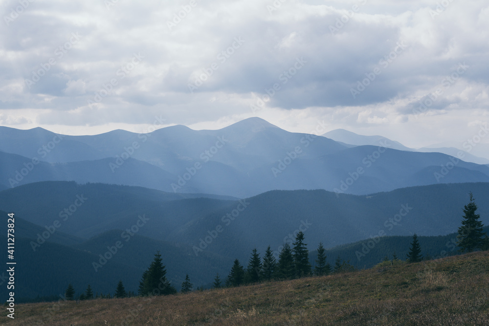 Cloudy day over Carpathian mountains with Hoverla in the center. Tonal perspective of moutain ranges