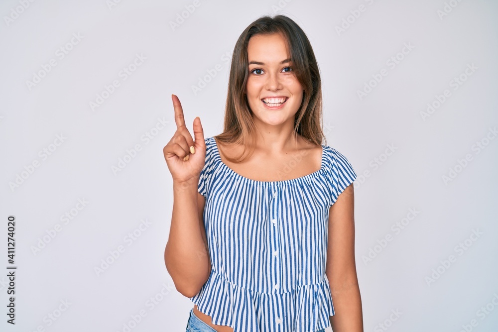 Beautiful caucasian woman wearing casual striped shirt smiling with an idea or question pointing finger up with happy face, number one Beautiful caucasian woman wearing casual striped shirt smiling with an idea or question pointing finger up with happy face, number one